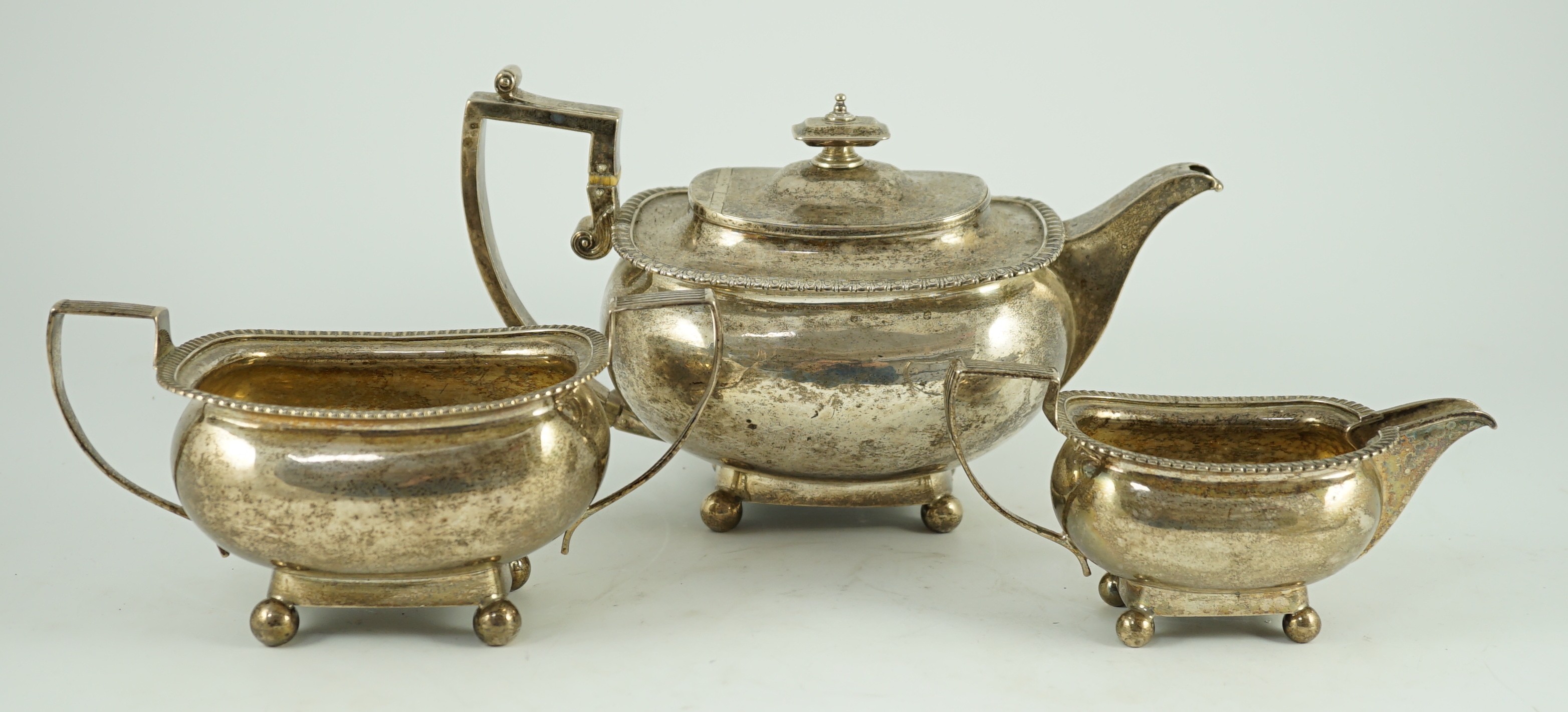 A George III silver three piece 'London' shape tea service, by Samuel Hennell